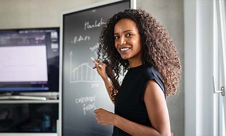 Women standing in front of blackboard