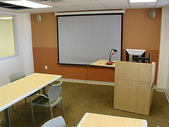 study room with a projector, podium, and working area